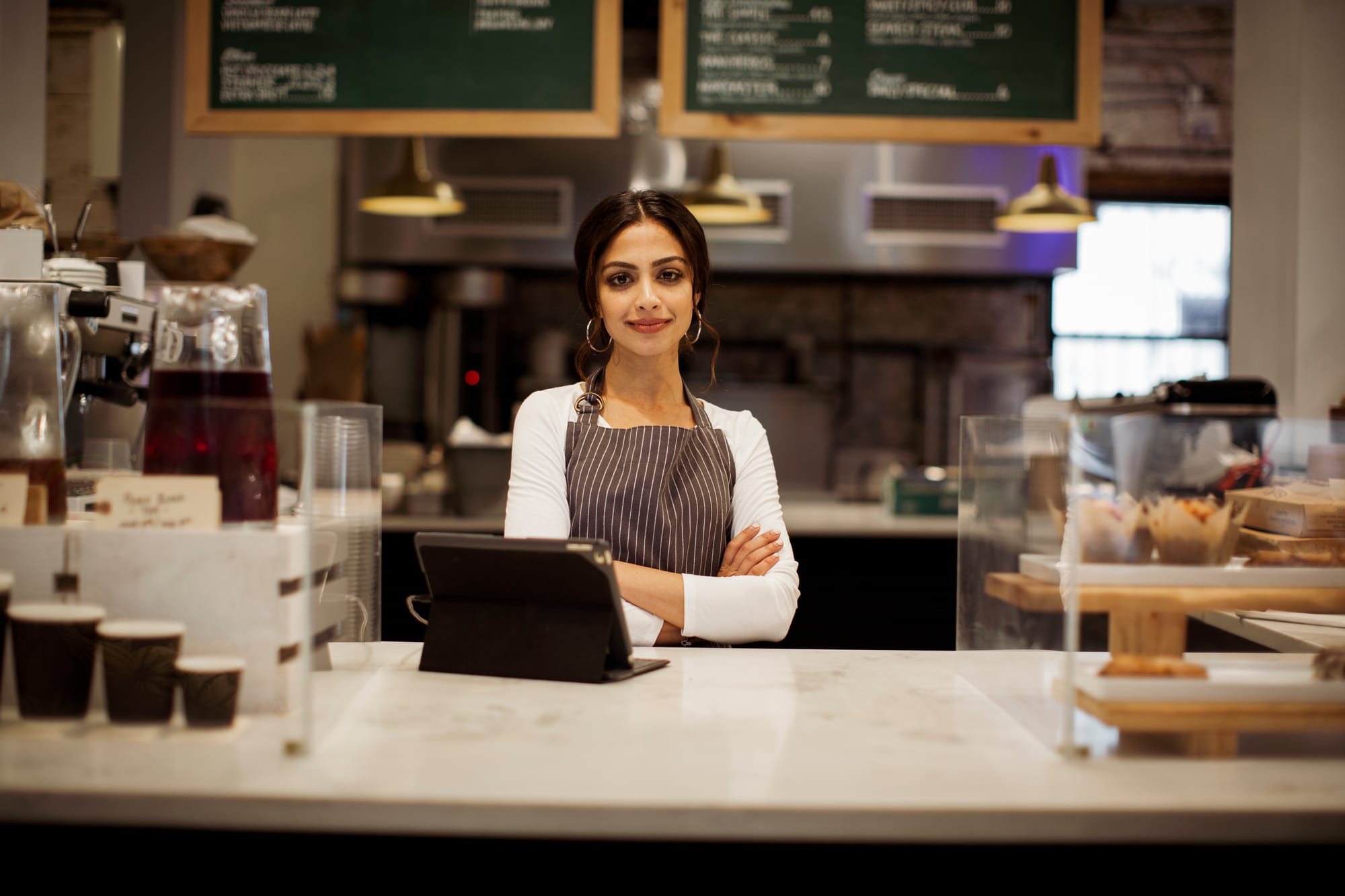 Small business owner reviewing cybersecurity risks at MarySues Tropical Café.